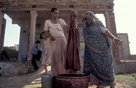 Working People in a textile coloring and dryeing Factory in the City of Jaipur in the Province of Rajasthan in India.  India, Jaipur, January, 1998