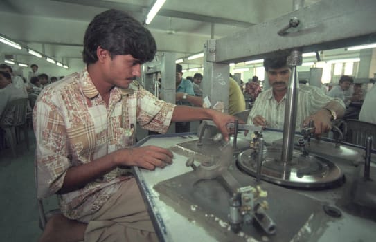 Working People in a Factory of gemstone cutting in the City of Jaipur in the Province of Rajasthan in India.  India, JAIPUR, January, 1998