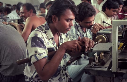 Working People in a Factory of gemstone cutting in the City of Jaipur in the Province of Rajasthan in India.  India, JAIPUR, January, 1998