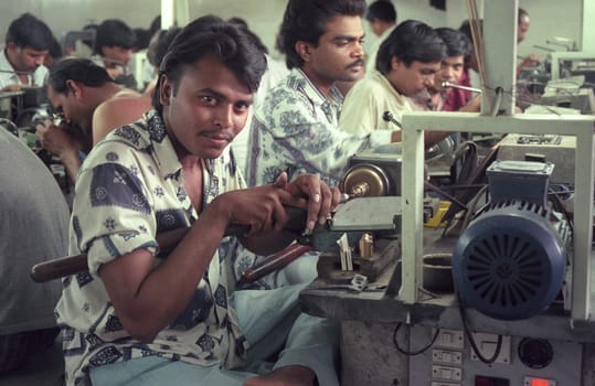 Working People in a Factory of gemstone cutting in the City of Jaipur in the Province of Rajasthan in India.  India, JAIPUR, January, 1998