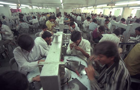 Working People in a Factory of gemstone cutting in the City of Jaipur in the Province of Rajasthan in India.  India, JAIPUR, January, 1998