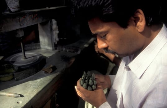Working People in a Factory of gemstone cutting in the City of Jaipur in the Province of Rajasthan in India.  India, JAIPUR, January, 1998