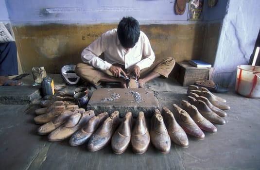 a Shoe maker in a shoe Factory in the City of Jaipur in the Province of Rajasthan in India.  India, JAIPUR, January, 1998