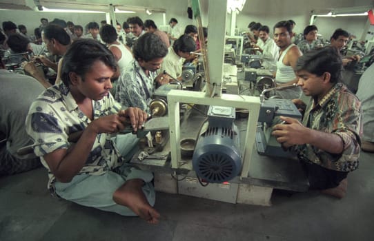 Working People in a Factory of gemstone cutting in the City of Jaipur in the Province of Rajasthan in India.  India, JAIPUR, January, 1998
