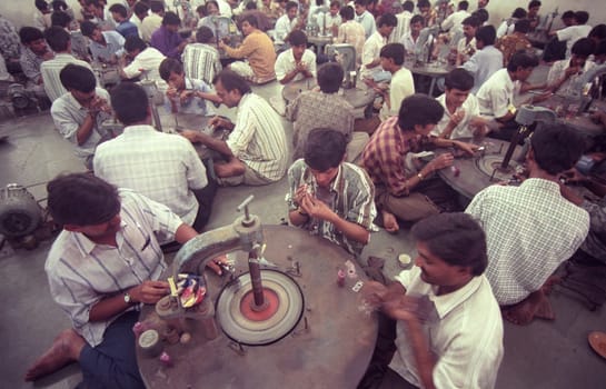 Working People in a Factory of gemstone cutting in the City of Jaipur in the Province of Rajasthan in India.  India, JAIPUR, January, 1998