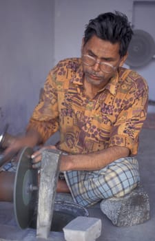 Working People in a Factory of gemstone cutting in the City of Jaipur in the Province of Rajasthan in India.  India, JAIPUR, January, 1998