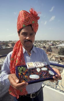 The Boss of a  Gemstone Trading company and Factory of gemstone cutting in the City of Jaipur in the Province of Rajasthan in India.  India, JAIPUR, January, 1998