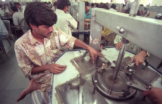 Working People in a Factory of gemstone cutting in the City of Jaipur in the Province of Rajasthan in India.  India, JAIPUR, January, 1998