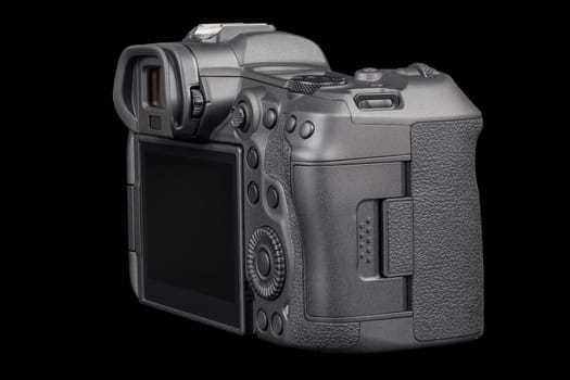 black 2020s professional 35mm full-frame mirrorless camera body with flip screen isolated on black background.