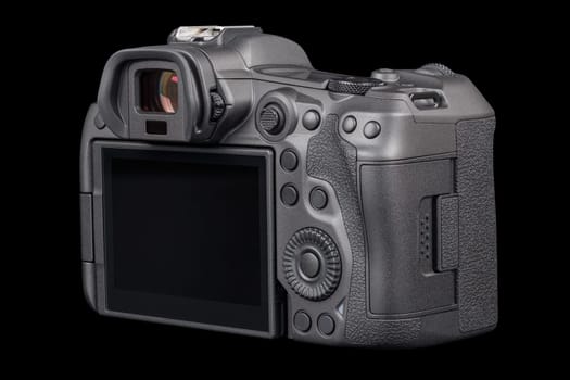 black 2020s professional 35mm full-frame mirrorless camera body with flip screen isolated on black background.