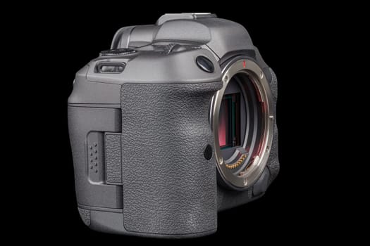 black 2020s professional 35mm full-frame mirrorless camera body with flip screen isolated on black background.