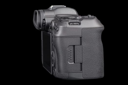 black 2020s professional 35mm full-frame mirrorless camera body with flip screen isolated on black background.
