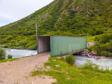 bridge over mountain river made of freight container.