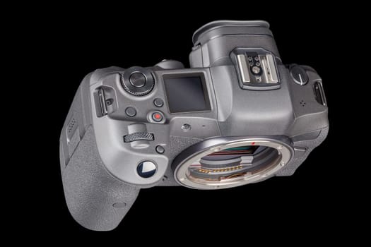 black 2020s professional 35mm full-frame mirrorless camera body with flip screen isolated on black background.