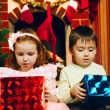 two beautiful child with gift at new year's eve