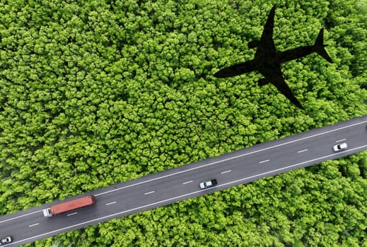 Sustainable transport. Aerial view of eco-friendly vehicles on highway. Electric cars, hydrogen trucks, and SAF-powered airplane shadow over lush green forest. Future of clean energy transportation.