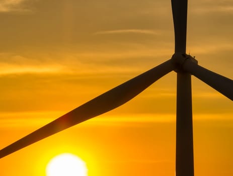 Wind farm field and sunset sky. Wind power. Sustainable, renewable energy. Wind turbines generate electricity. Sustainable development. Green technology for energy sustainability. Eco-friendly energy.