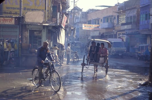 the Traffic with Bicycle and horse cart in the Blue City and Town of Jodhpur in the Province of Rajasthan in India.  India, Jodhpur, January, 1998