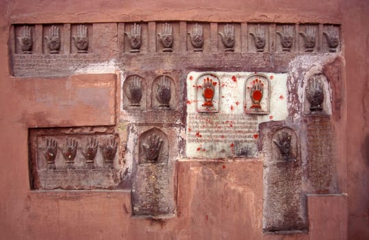 Women Queens Handprints of Sati and grid of Sculpted hands at the Meherangarh in the Town of Jodhpur in the Province of Rajasthan in India.  India, Jodhpur, January, 1998