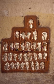 Women Queens Handprints of Sati and grid of Sculpted hands at the Meherangarh in the Town of Jodhpur in the Province of Rajasthan in India.  India, Jodhpur, January, 1998