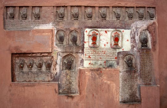 Women Queens Handprints of Sati and grid of Sculpted hands at the Meherangarh in the Town of Jodhpur in the Province of Rajasthan in India.  India, Jodhpur, January, 1998
