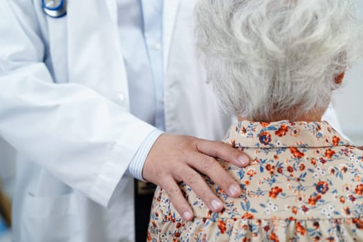 Asian doctor touching patient to support, consolation encourage and help support health care medical.