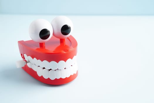 Funny red teeth with eye toy denture model for dental health care.