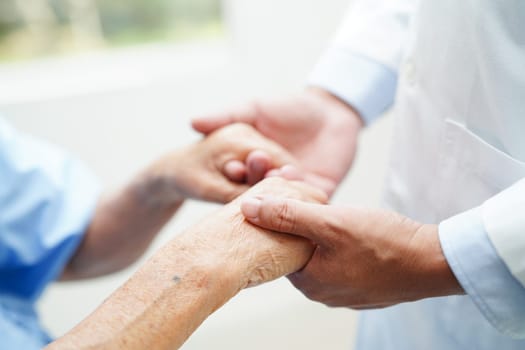 Asian doctor touching patient to support, consolation encourage and help support health care medical.