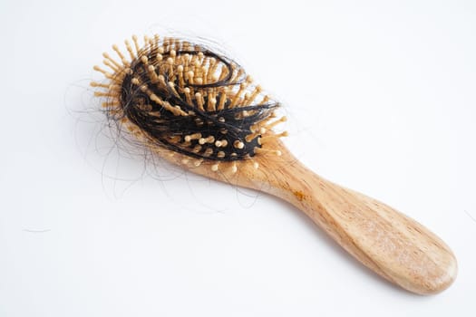 Asian woman have problem with long hair loss attach to comb brush.