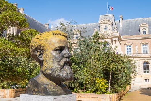Amiens, France – September 12, 2024: City Hall and bronze buste of Jules Verne, famous French writer and adventurer, by artist and sculptor Philippe Arnault
