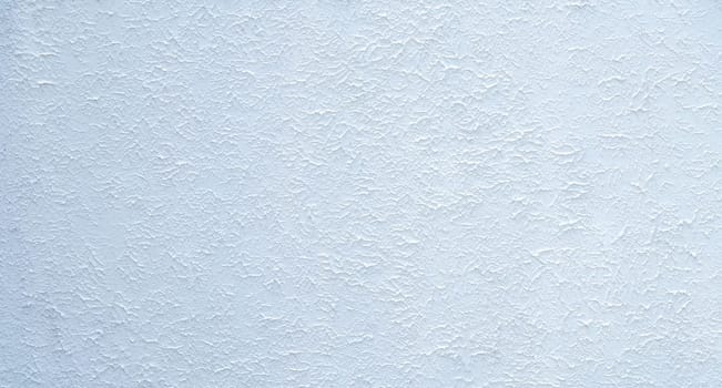 Close-up of white textured concrete building wall with rough surface, ideal for backgrounds or architectural design concepts. Modern and minimalist white wall with a raw, industrial feel. Empty space.