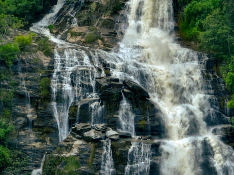 Aerial view of a waterfall in a lush tropical green forest in Doi Inthanon National Park, Chiang Mai, Thailand. This nature landscape showcases water sustainability and scenic travel destinations.
