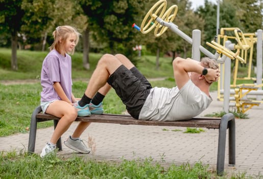 Father And Daughter Happily Training Together With Golden Retriever Dog This Summer, Pumping Up The Press