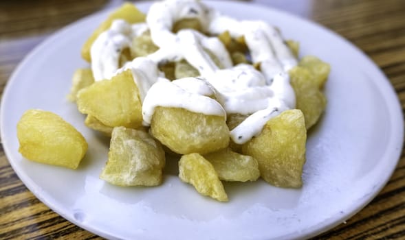 Detail of cold potatoes with sauce, lunch and fun