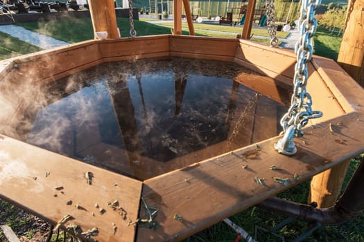 Big vat with hot water and herbs for bathing, spa and relax. Outdoor in Altai mountains, Siberia, Russia