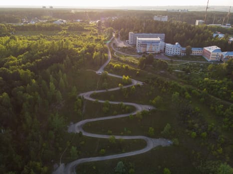 Aerial top vew of winding road in the city, drone shot