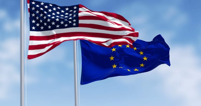 The flags of the United States of America and the European Union waving in the wind on a clear day. 3D illustration render. Rippled fabric. Selective focus. International politics, alliance