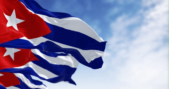Close-up of Cuba national flags waving on a clear day. Five blue and white stripes, a red triangle at the hoist with a white star. Latin american country. 3d illustration render. Fluttering fabric.