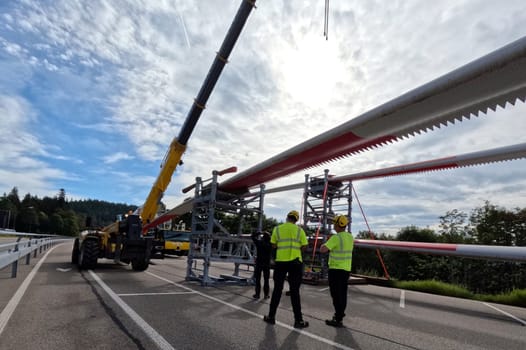 A last check up,the rotors are still supported by a heavy metal block,then the journey to the Schauinsland begins  The heavy transport of the 68-metre-long rotor blades leads over the Feldberg (Breisgau-Hochschwarzwald district) to Freiburg's local mountain,the Schauinsland  The rotor blades are mounted on a self-propelled vehicle,and they reach their destination at walking pace over several days  Topic picture wind energy