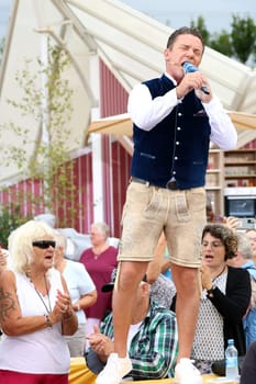 Standing on the beer table: Stefan Mross (singer / presenter / entertainer) in the ARD TV show "Immer wieder sonntags""."
