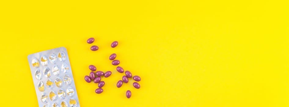 Nutritional supplement purple pills with empty blisters isolated on bold yellow background with copy space. Template for feminine beauty blog social media. Female healthcare concept