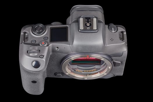 black 2020s professional 35mm full-frame mirrorless camera body with flip screen isolated on black background.