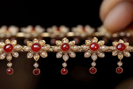 Luxurious gold jewelry set with rubies and pearls, featuring intricate floral designs and dangling elements.