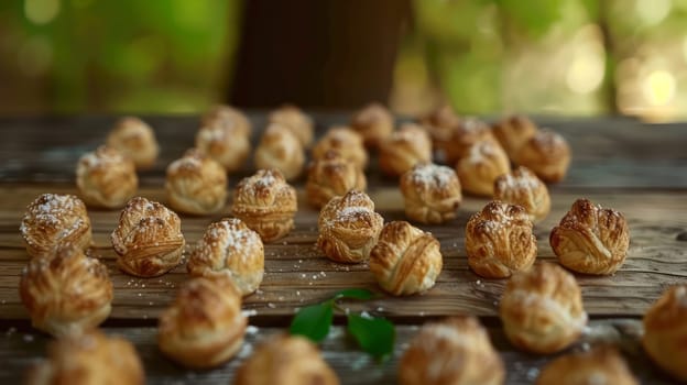 An outdoor table with a pile of cakes on it and a few leaves