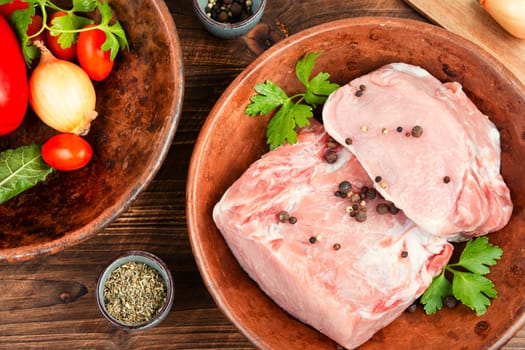 Slices of raw pork meat and vegetables.