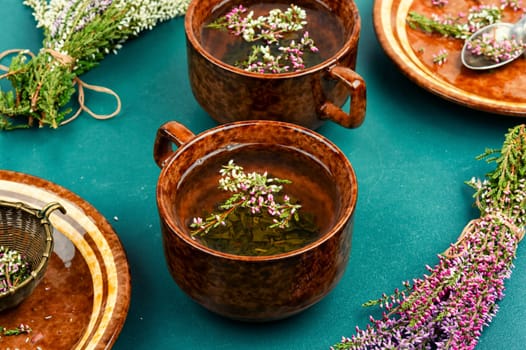 Natural herbal tea made from fresh heather. Alternative medicine and naturopathy concept.