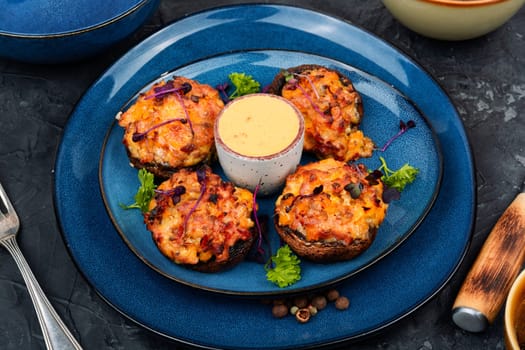 Delicious stuffed mushrooms, champignon mushroom caps stuffed with vegetables. Top view.