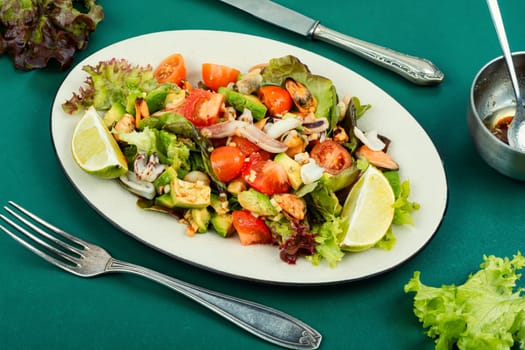 Salad with calamari, shrimp, clams and fresh vegetables. Copy space.