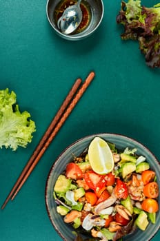 Salad with calamari, shrimp, clams and fresh vegetables. Copy space.