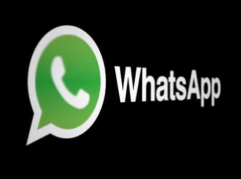 Menlo Park, US, May 2023: WhatsApp logo on a black background. Freeware, cross-platform, centralized instant messaging and voice-over-IP service. Illustrative editorial. Selective focus